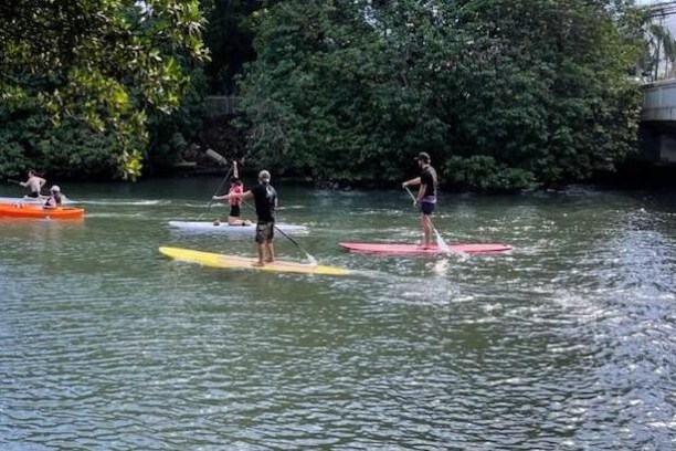 a group of people rowing a boat in the water